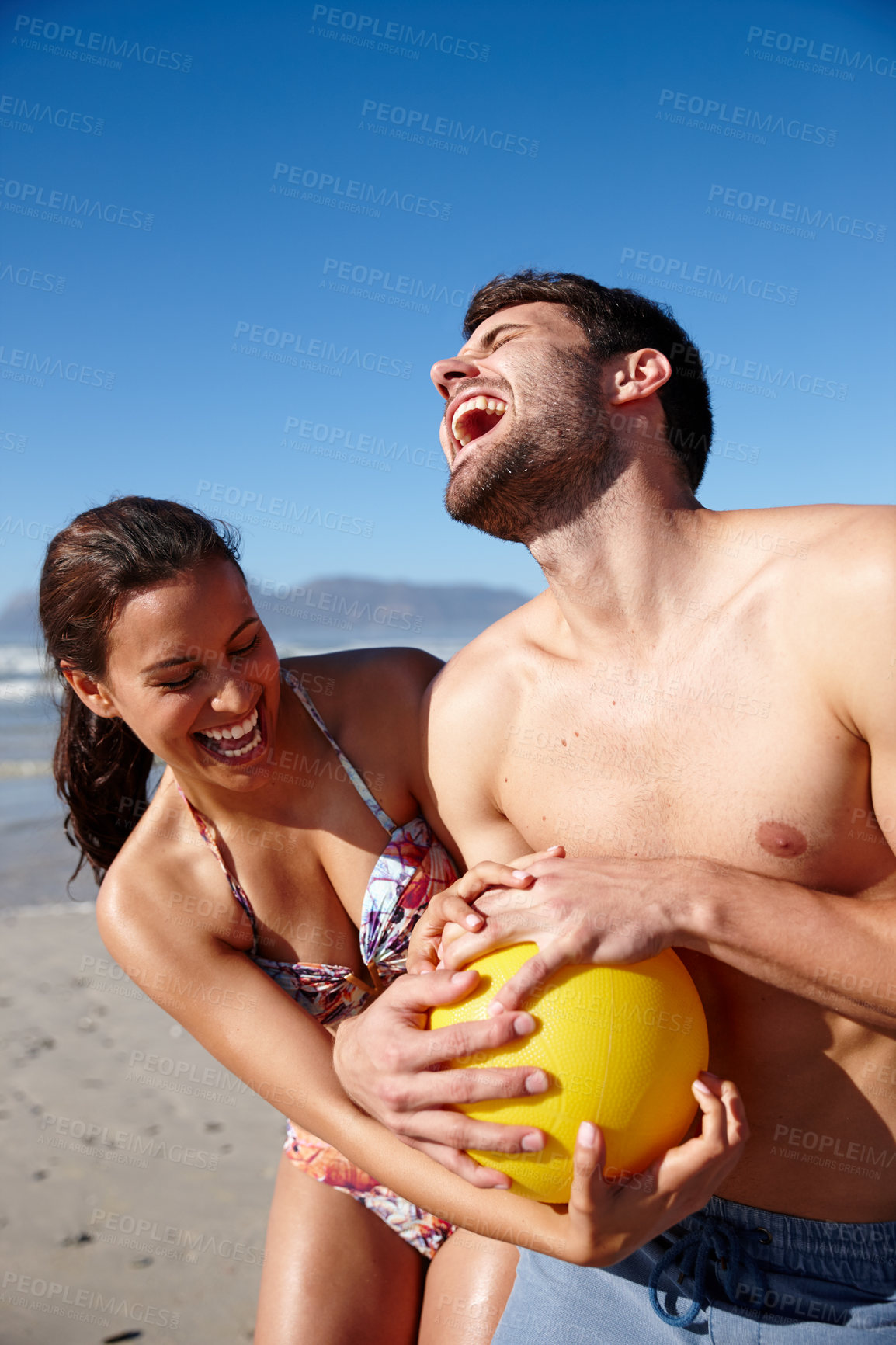 Buy stock photo Cropped shot of a happy couple playing with a ball together on a beach