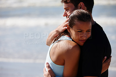 Buy stock photo Shot of an upset woman being comforted by her boyfriend