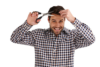 Buy stock photo Studio portrait of a handsome young man cutting his own hair isolated on white