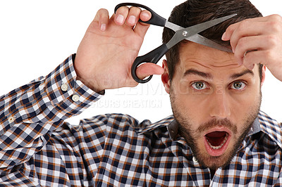 Buy stock photo Studio portrait of a handsome young man cutting his own hair isolated on white
