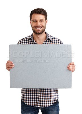 Buy stock photo Studio portrait of a handsome young man holding a blank placard isolated on white