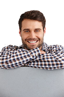 Buy stock photo Studio portrait of a handsome young man leaning on a blank placard isolated on white