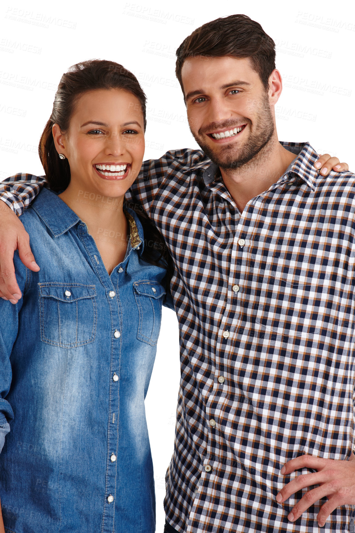 Buy stock photo Studio portrait of an affectionate young couple standing with their arms around each other isolated on white