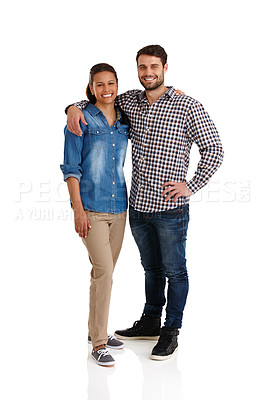 Buy stock photo Studio portrait of an affectionate young couple standing with their arms around each other isolated on white