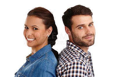 Buy stock photo Studio portrait of a happy young couple standing back to back isolated on whuite