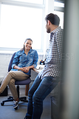 Buy stock photo Shot of a two colleagues chatting in an office
