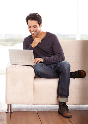 Buy stock photo Man, typing and work from home on laptop for graphic design career, planning and research on website and sofa. Startup freelancer or online designer relax on couch with computer and happy project