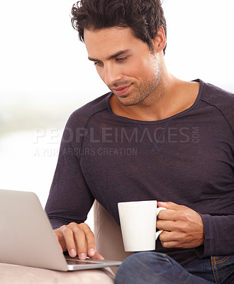 Buy stock photo Coffee, laptop and online with man on sofa for social media, networking and connection. Website, streaming and digital with person in living room at home for remote work, research and technology