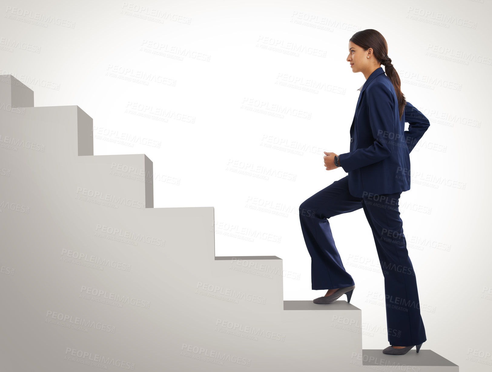 Buy stock photo Studio shot of a motivated businesswoman climbing a flight of stairs
