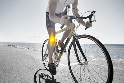 Buy stock photo Cropped view of a cyclist with knee issues cycling along an ocean road