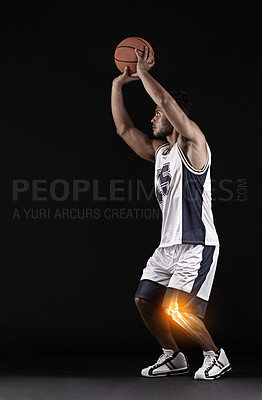 Buy stock photo Studio shot of a handsome young basketball player with an inflamed knee