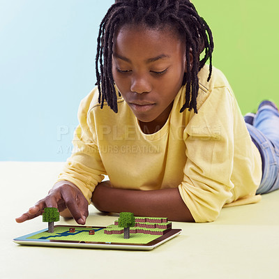 Buy stock photo Child, tablet and floor for online games, gamification or virtual entertainment with digital animation. African boy or kid with tech and concentrate with graphics for strategy and challenge for fun 