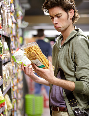 Buy stock photo Man, product and comparison choice in supermarket for label difference, nutrition value or grocery shopping. Male person, thinking and decision for shop aisle deal, wholesale price or discount search