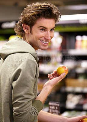 Buy stock photo A young man at the store buying fruit