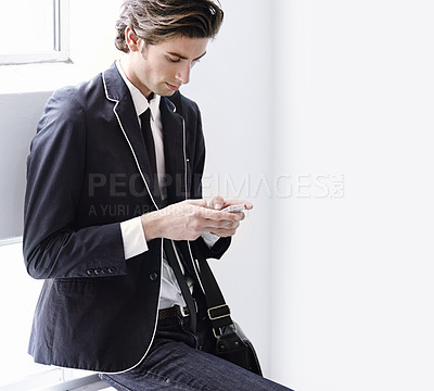 Buy stock photo Fashion, phone and young man networking on social media, mobile app or the internet with formal outfit. Chat, communication and male person scroll on a cellphone with classy, cool and elegant style.