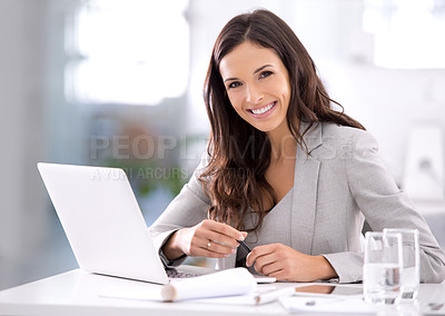 Buy stock photo Happy, confident and ambitious business woman working on her laptop while sitting at her desk. Portrait of a beautiful female entrepreneur showing great leadership skills while working in an office 
