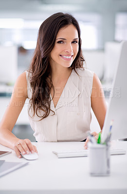 Buy stock photo Smiling, confident and young female business worker sitting at a office computer. Portrait of a market research consultant doing advertising. Beautiful woman employee feeling positive about marketing