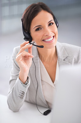 Buy stock photo Shot of a call center operator sitting infront of her computer