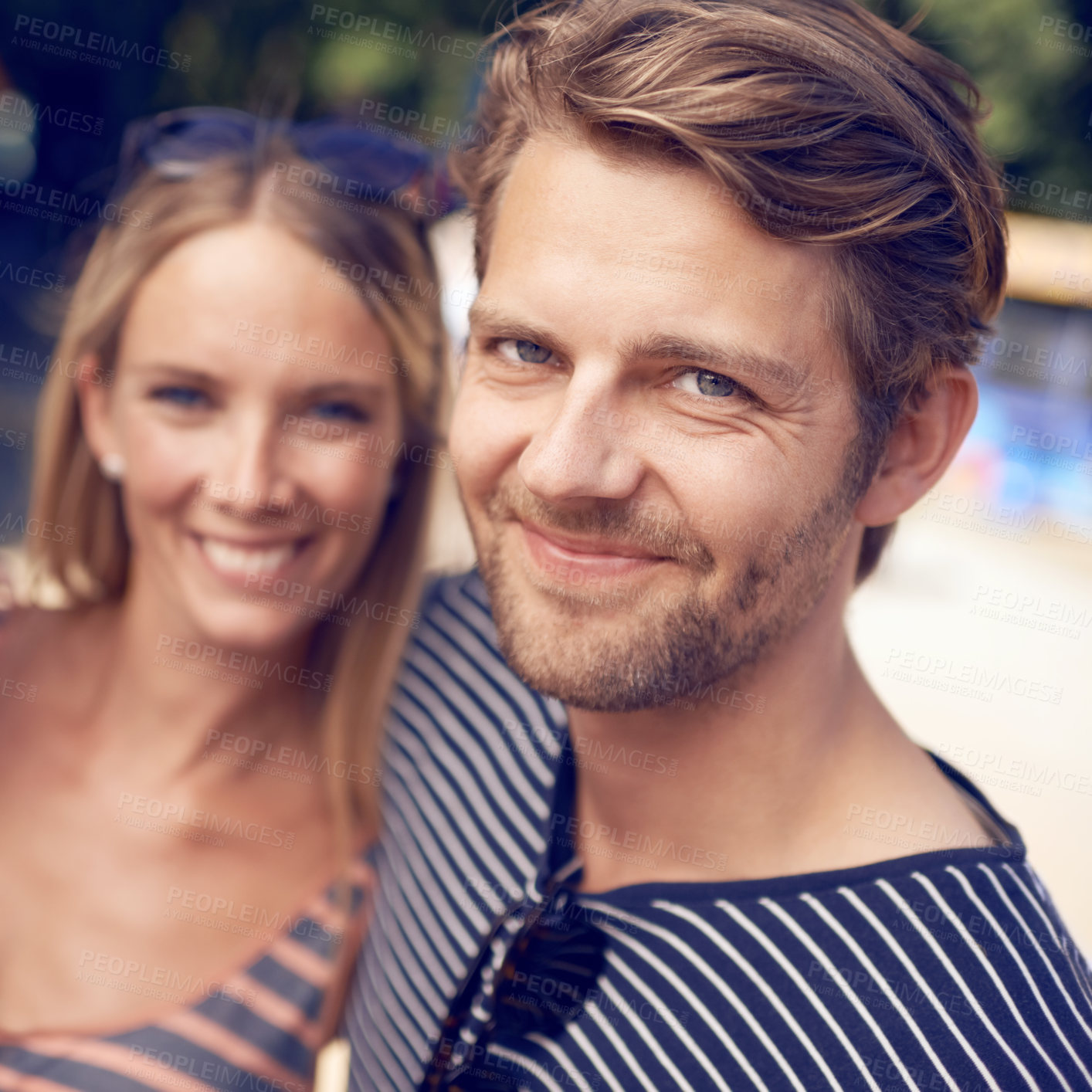 Buy stock photo Portrait of an attractive couple standing together and smiling