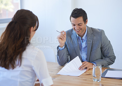 Buy stock photo A young businessman going over a candidates impressive resume at a job interview