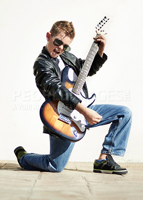 Buy stock photo Portrait of boy with guitar, rock pose and creative sound, playing audio and cool young musician with sunglasses. Music, excited child guitarist in performance and talent show for hipster children.