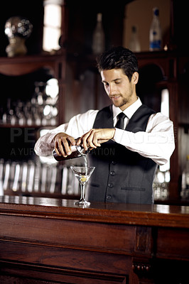 Buy stock photo Bartender man, glass and mixing cocktail at bar for service, drink or hospitality at party, club or event. Male server, barman or waiter with alcohol, spirit or mixer for presentation at restaurant