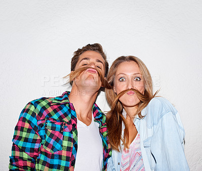 Buy stock photo Portrait, funny and couple with moustache hair, silly and happiness isolated against a grey studio background. Face, man and woman with facial expression, goofy or partners with joy, bonding and love