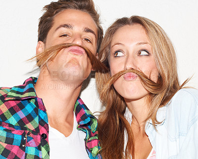 Buy stock photo Playful, portrait and couple with hair mustaches being funny, comic and quirky together in a studio. Crazy, young and a man and woman being silly and goofy on a date isolated on a white background