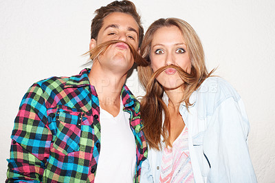 Buy stock photo Silly portrait of couple with hair moustache, funny face and gen z fashion with university culture in youth. Happiness, woman and hipster man in crazy picture at fun college event on wall background.