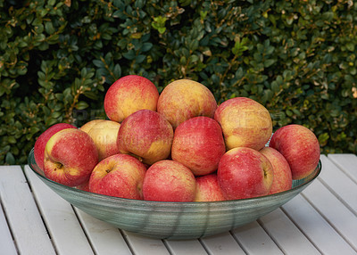 Buy stock photo Red apples in a bowl, outdoor and nutrition with protein, healthy snack and treat with diet plan and harvest. Organic, fruit and vitamins with nature, picnic table and produce with fiber and wellness