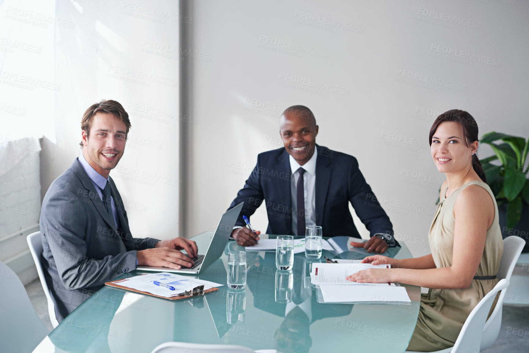 Buy stock photo Portrait of a group of businesspeople sitting around a conference table