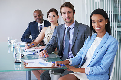Buy stock photo Portrait of a group of businesspeople sitting at a conference table