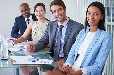Buy stock photo Portrait of a group of businesspeople sitting at a conference table
