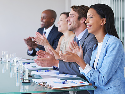 Buy stock photo Shot of businesspeople applauding a presentation at a work conference