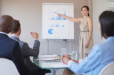 Buy stock photo Shot of a business manager presenting financial data to her colleagues during a meeting