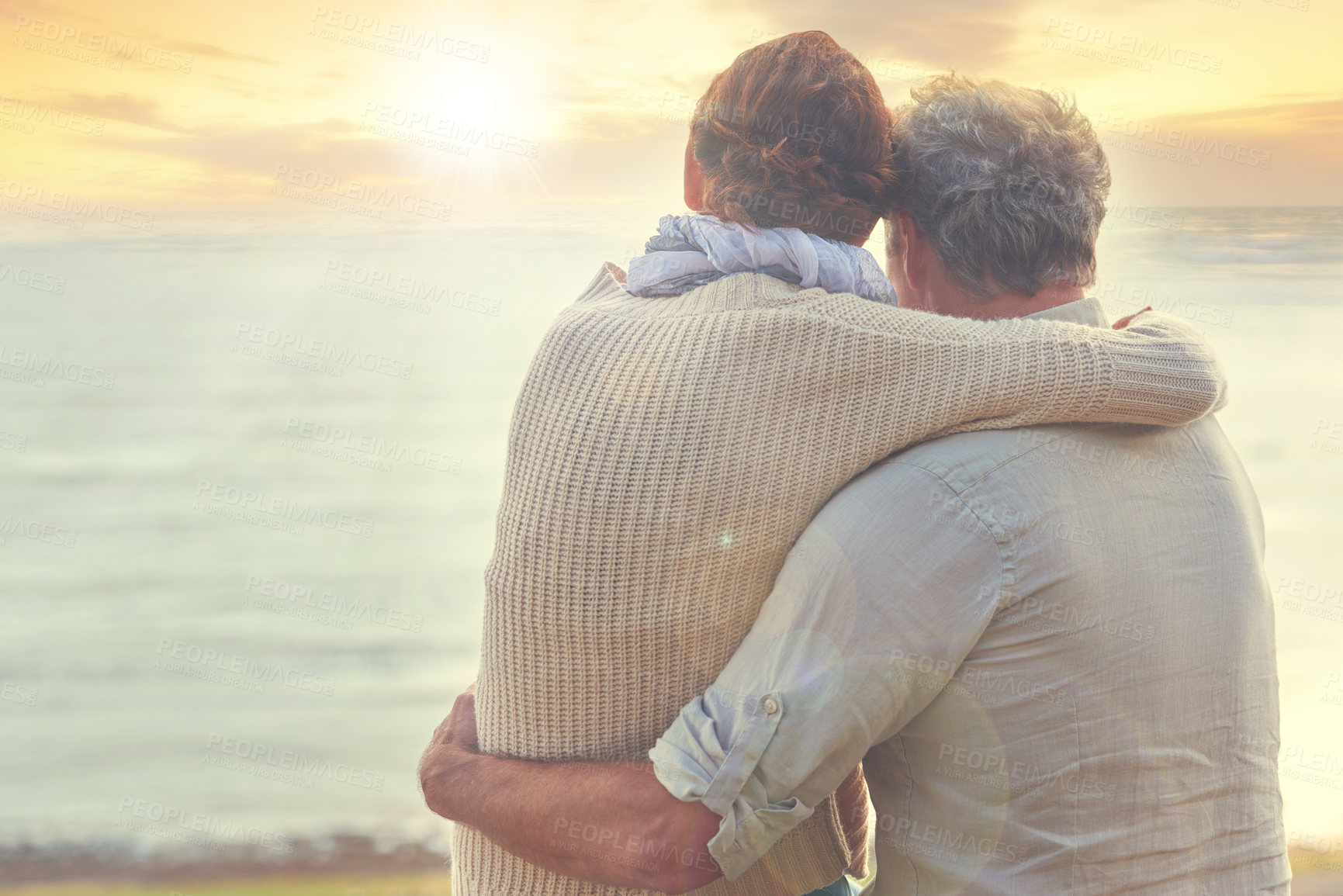 Buy stock photo Old couple, hug and sunset on sea at the beach with care, support and trust in marriage or retirement. Back, man and woman in embrace with love, kindness and gratitude for vacation or holiday