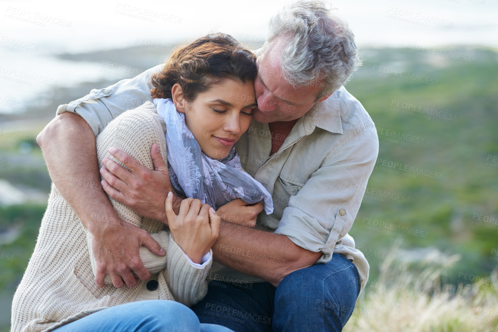 Buy stock photo Couple, face and smile outdoor with hug for romance, love and relationship in nature with relaxing. Mature, man and woman or embrace with happy, peace and comfort for bonding, honeymoon and support 