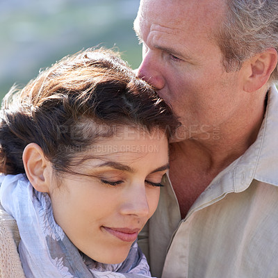 Buy stock photo Couple, forehead kiss and love with respect or happiness on holiday in retirement. Mature, man and woman embrace together outdoor on vacation in nature or show affection or gratitude in marriage