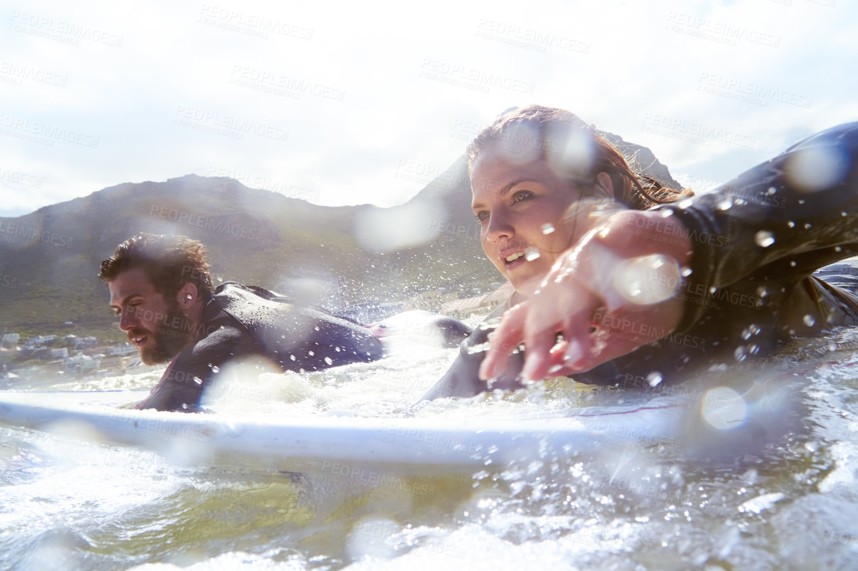 Buy stock photo Shot of a young couple out surfing together