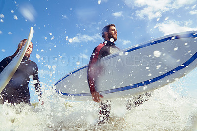 Buy stock photo Shot of a young couple out surfing together