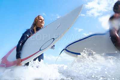 Buy stock photo Shot of a young couple out surfing together