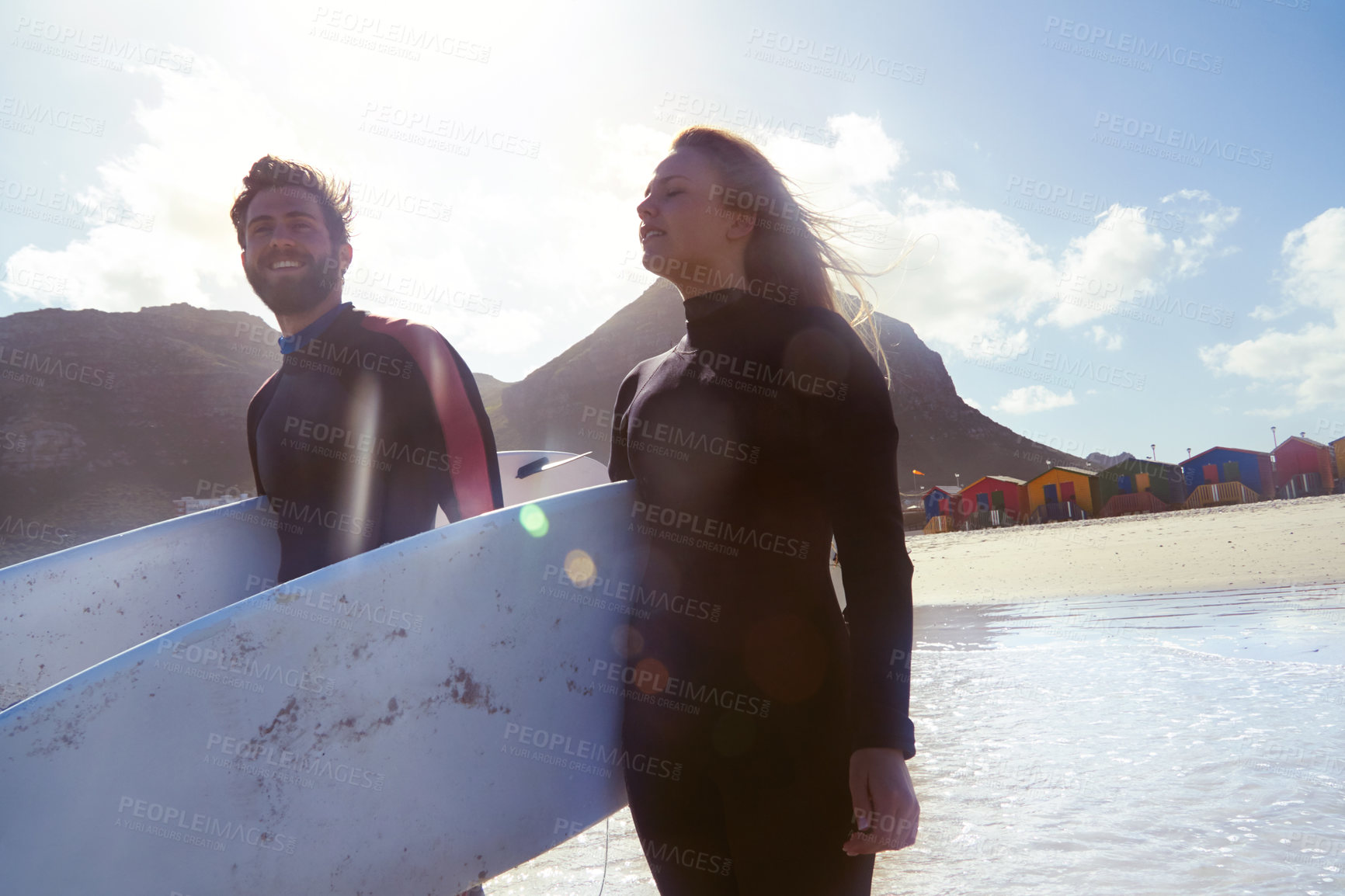 Buy stock photo Shot of an athletic young couple surfing at their favourite beach