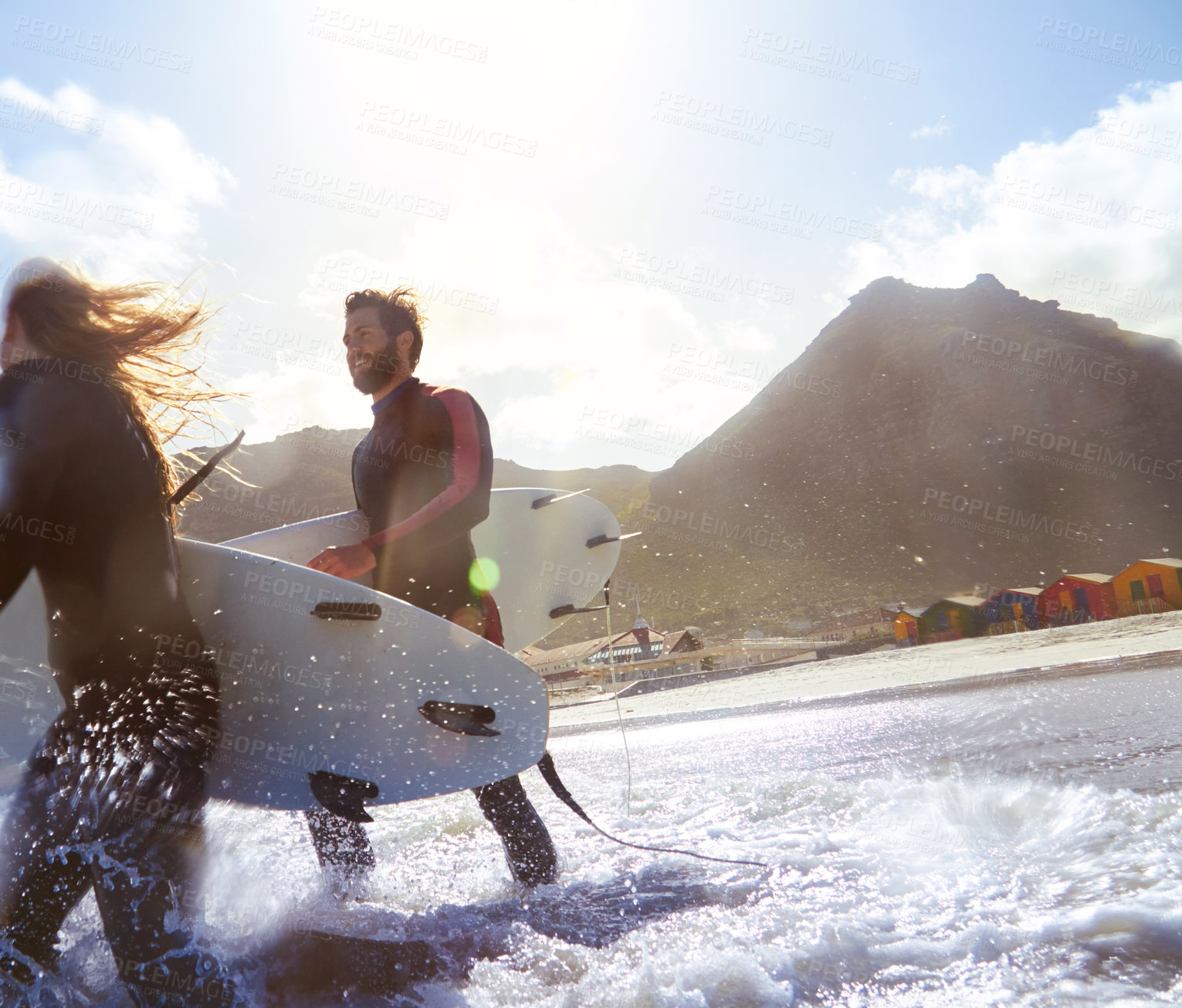 Buy stock photo Shot of an athletic young couple surfing at their favourite beach