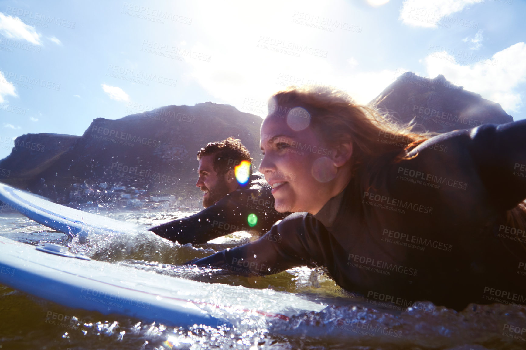 Buy stock photo Shot of an athletic young couple surfing at their favourite beach