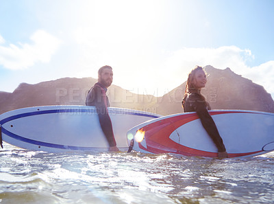 Buy stock photo Shot of a young couple out surfing together