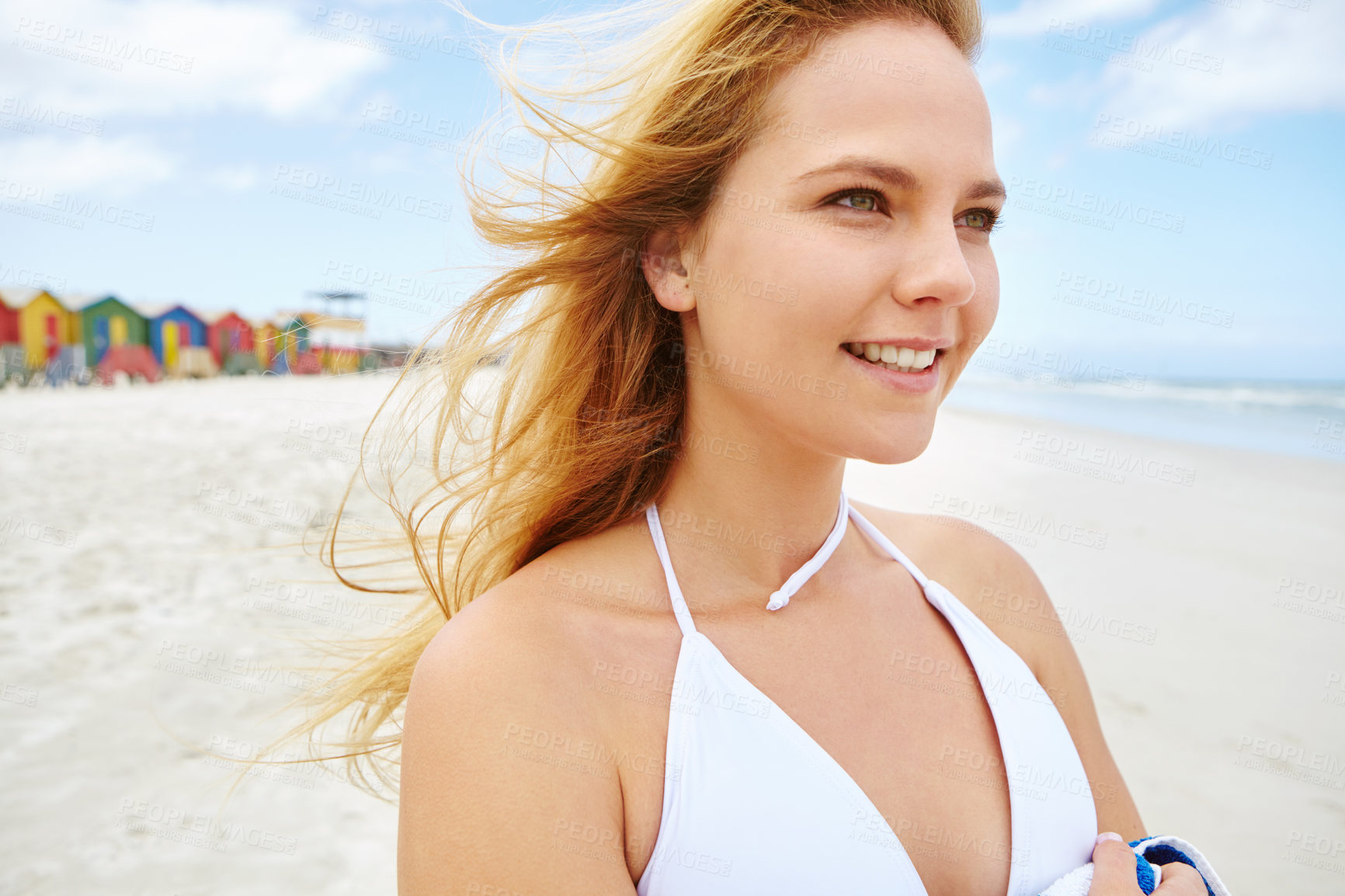 Buy stock photo Cropped shot of a beautiful young woman standing on the beach