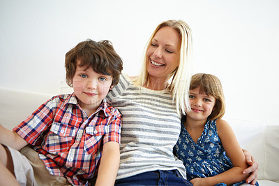 Buy stock photo Shot of a happy family spending quality time together at home on the sofa