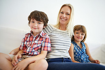 Buy stock photo Shot of a happy family spending quality time together at home on the sofa