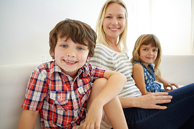 Buy stock photo Shot of a happy family spending quality time together at home on the sofa