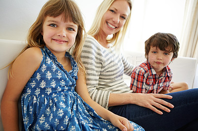 Buy stock photo Shot of a happy family spending quality time together at home on the sofa